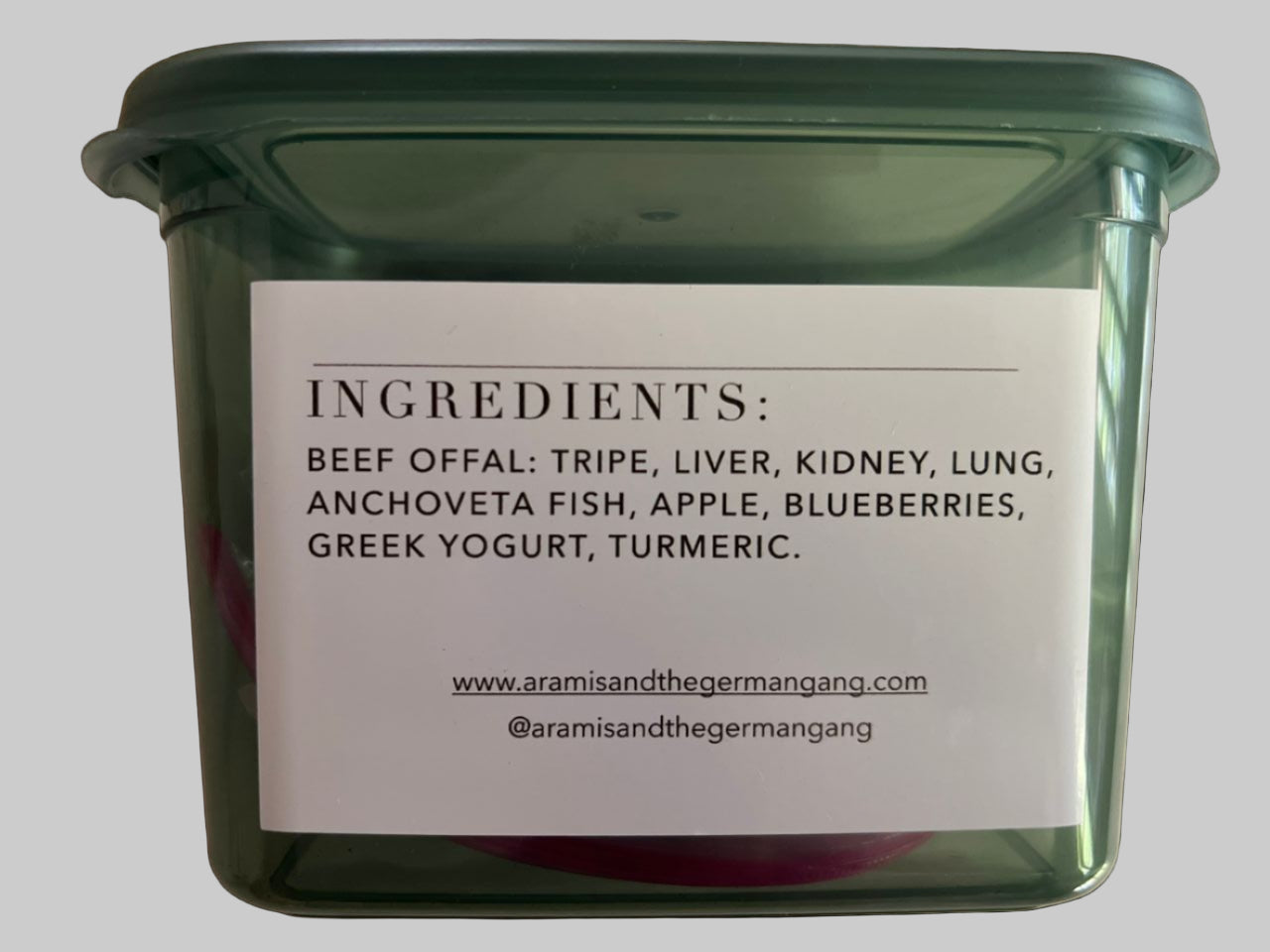 Green container with a label listing ingredients